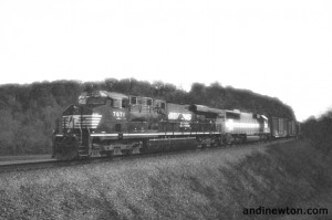 a grainy black and white photo of a freight train
