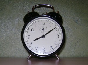 An old-style black alarm clock