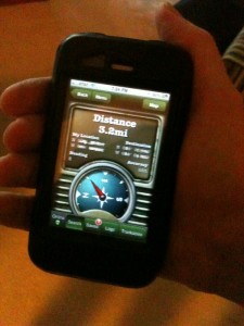 A geocaching app showing a compass on an iPhone